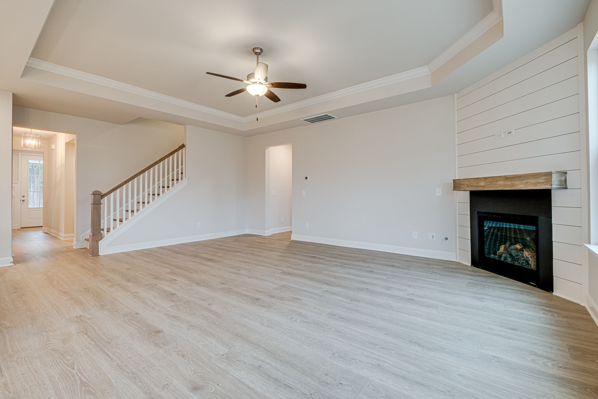3017 Fanshaw Road Smyrna, TN 37167 - Photo 9 of 39 a view of an empty room with wooden floor fireplace and a window