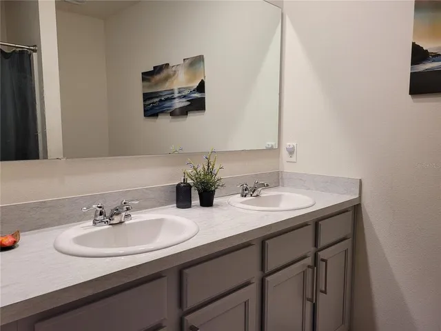 a living room with furniture a fireplace and a large window