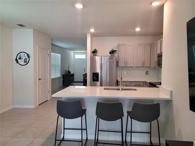 a large kitchen with a table and chairs