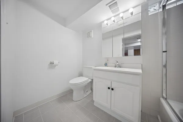 a bathroom with a sink mirror and toilet