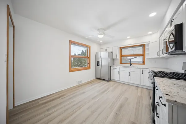 a view of a kitchen with microwave and cabinets