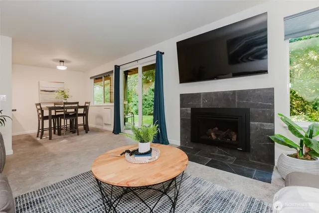 a living room with furniture a flat screen tv and a fireplace