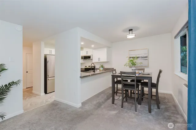 a view of a dining room with furniture window and outside view