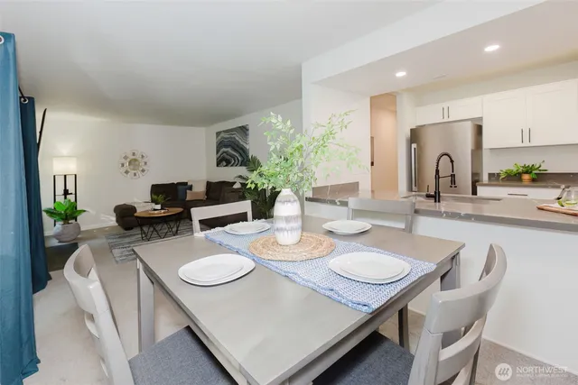 a living room with furniture a dining table with kitchen view