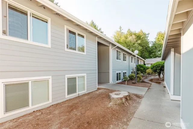 a view of a house with backyard and sitting area
