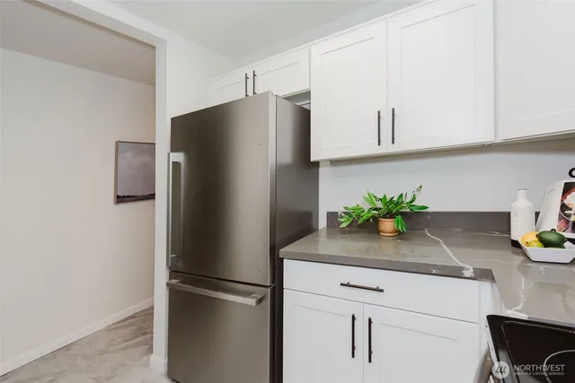 a kitchen with stainless steel appliances granite countertop a sink and a window