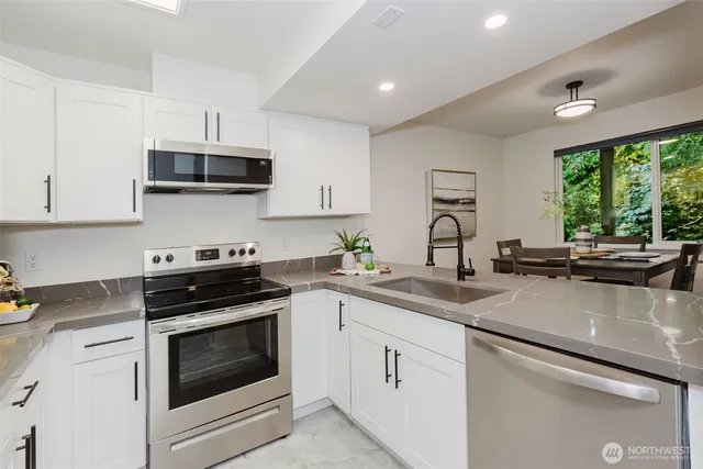 a kitchen with a table and chairs in it