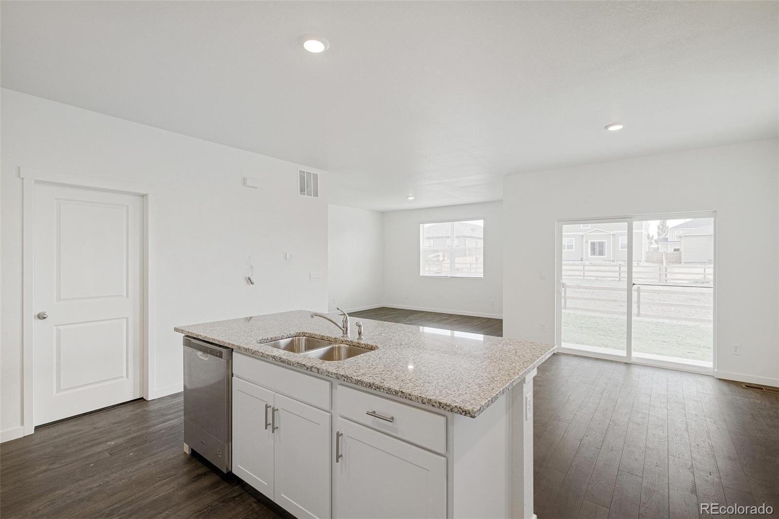 522 Twilight Court Fort Lupton, CO 80621 - Photo 17 of 29 a kitchen with a sink cabinets and wooden floor