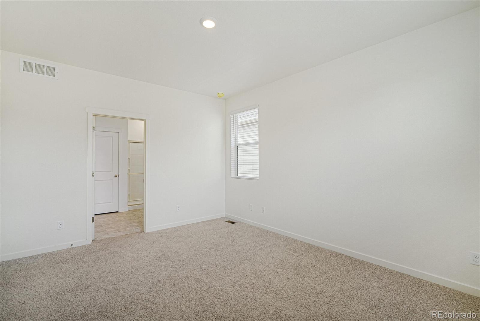 522 Twilight Court Fort Lupton, CO 80621 - Photo 19 of 29 an empty room with windows