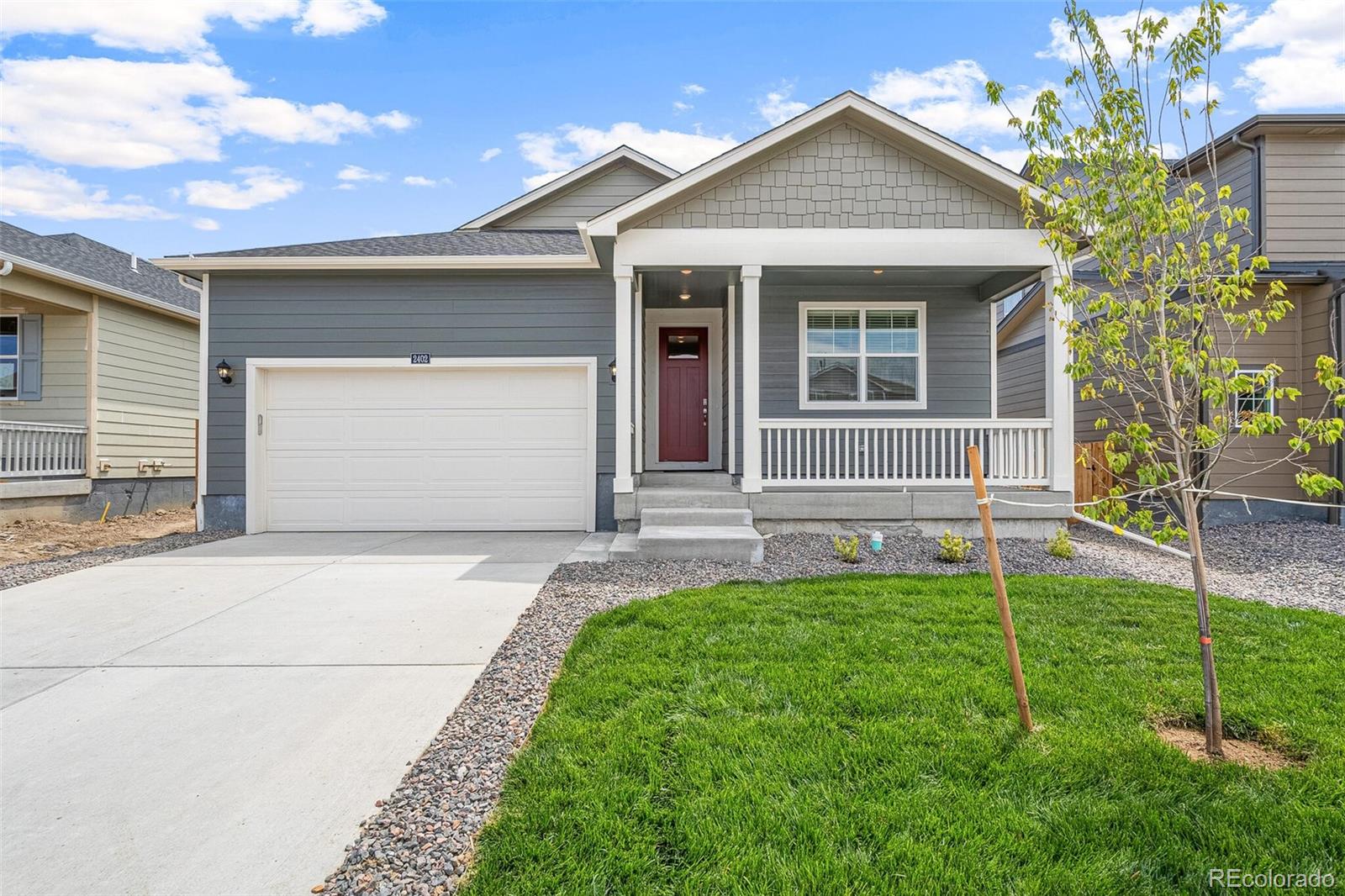 522 Twilight Court Fort Lupton, CO 80621 - Photo 2 of 29 a front view of a house with a yard and garage