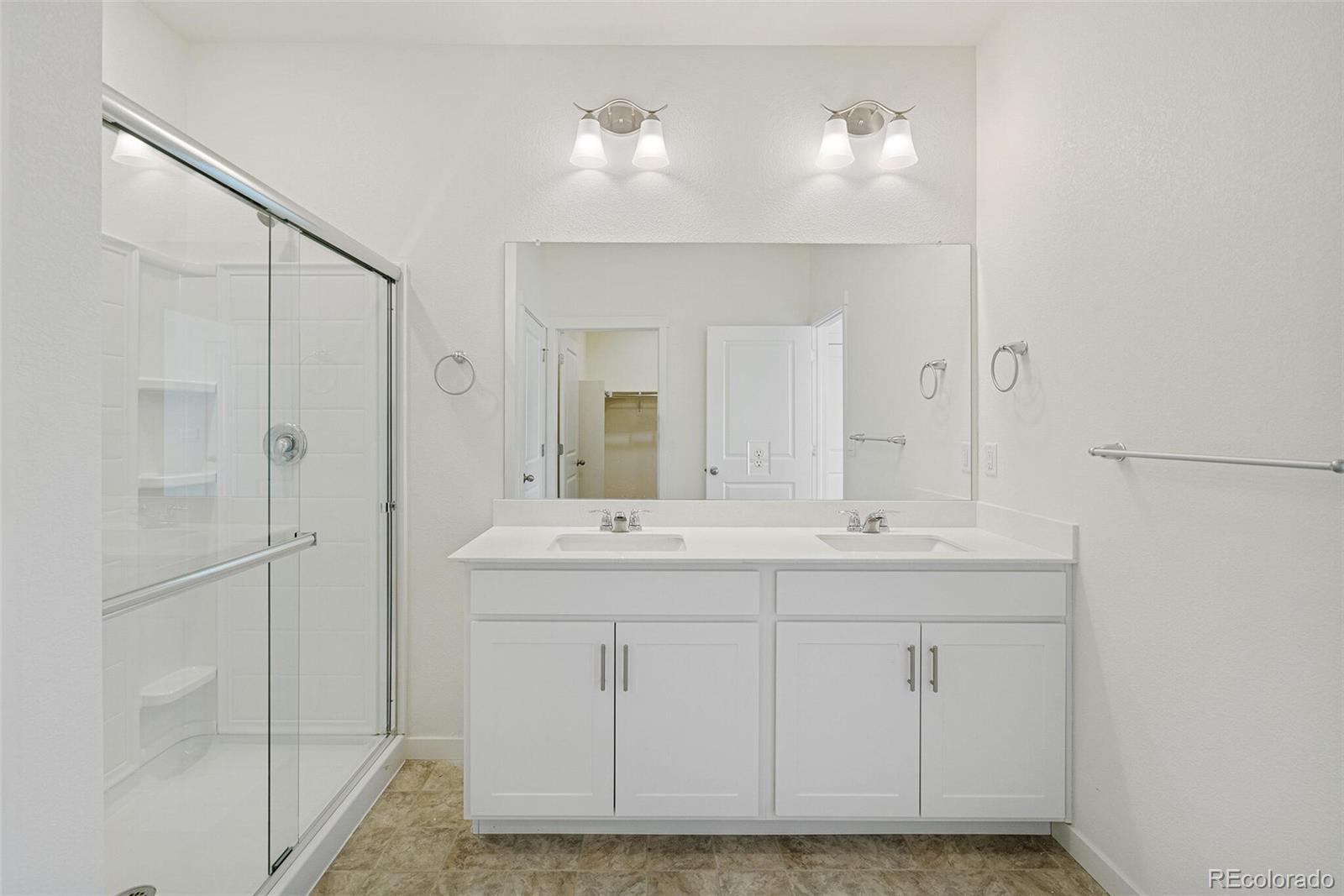 522 Twilight Court Fort Lupton, CO 80621 - Photo 21 of 29 a bathroom with a sink and a mirror