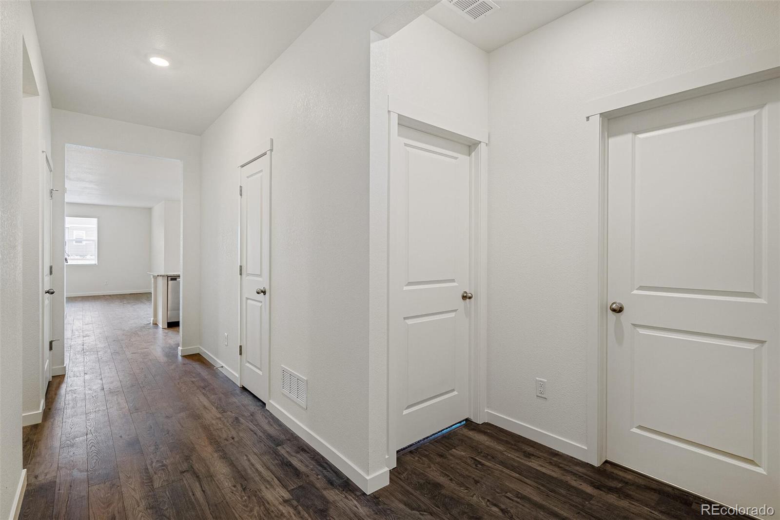 522 Twilight Court Fort Lupton, CO 80621 - Photo 23 of 29 a view of hallway with wooden floor