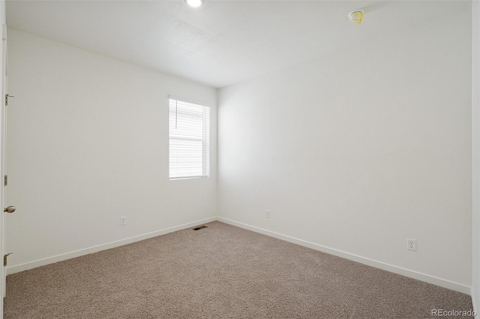 522 Twilight Court Fort Lupton, CO 80621 - Photo 27 of 29 an empty room with a window