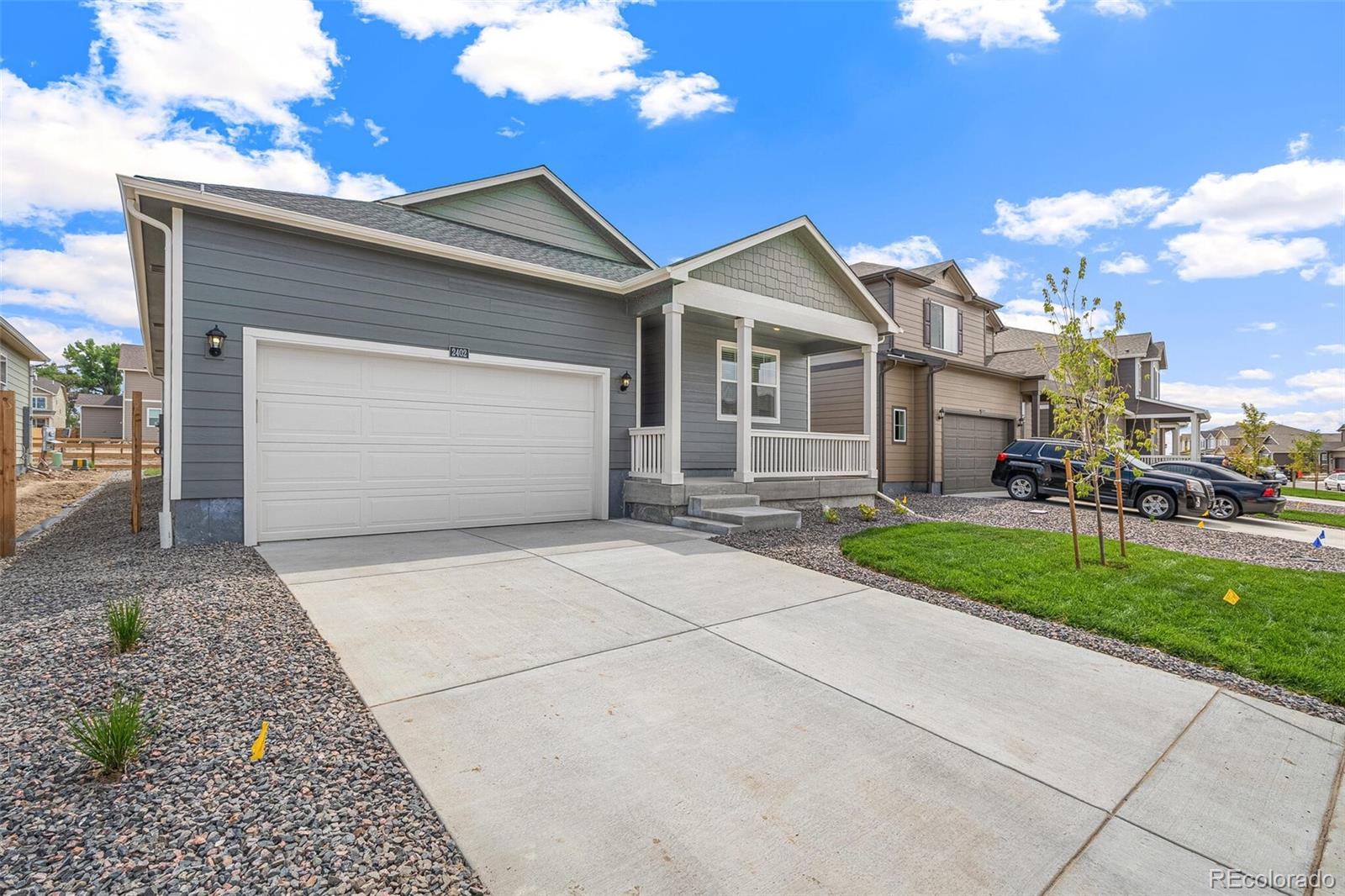 522 Twilight Court Fort Lupton, CO 80621 - Photo 4 of 29 a front view of a house with a yard and garage