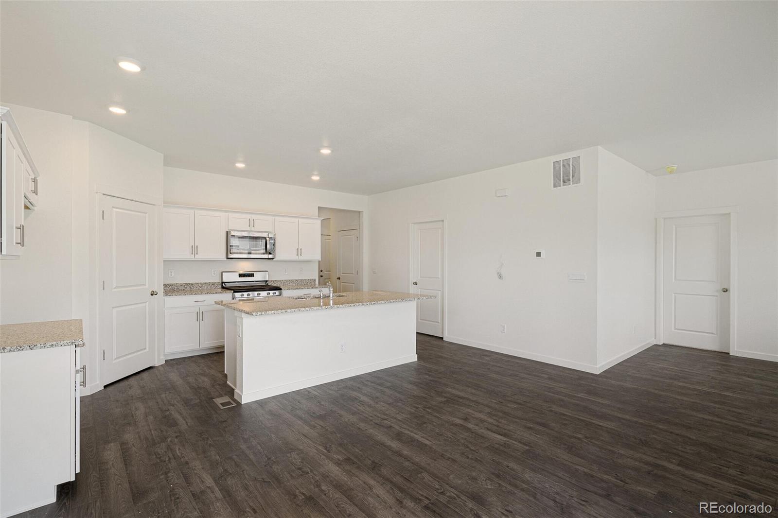 522 Twilight Court Fort Lupton, CO 80621 - Photo 8 of 29 a view of kitchen with wooden floor