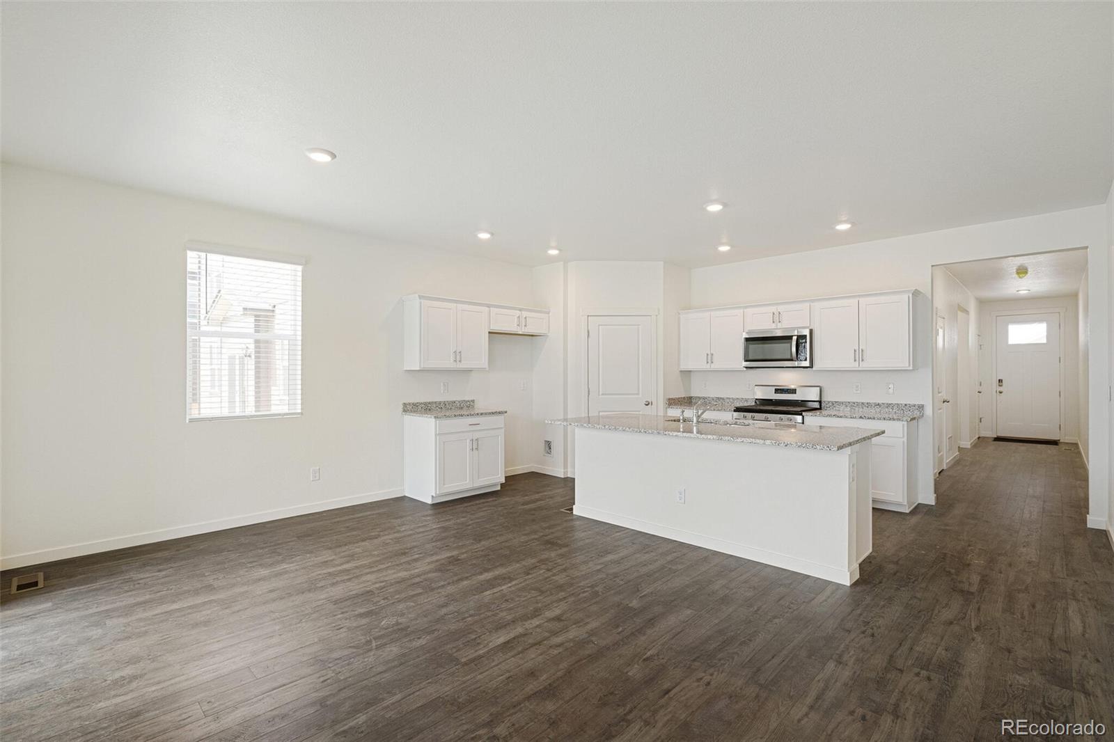 522 Twilight Court Fort Lupton, CO 80621 - Photo 9 of 29 a view of kitchen with sink and wooden floor