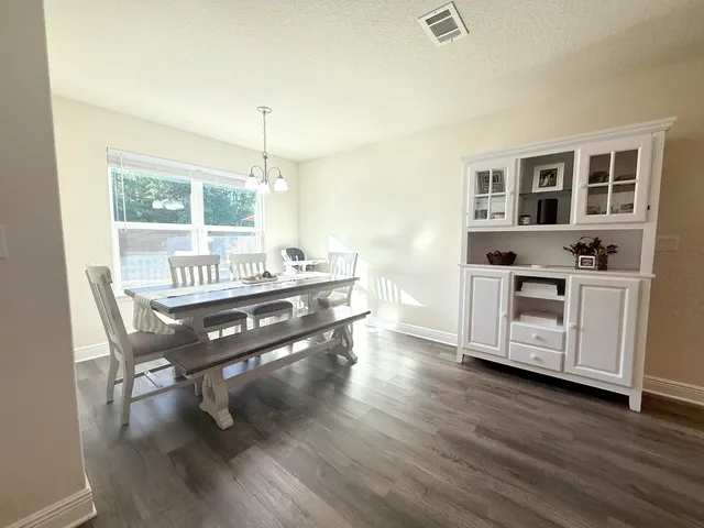 a view of a workspace with furniture window and wooden floor