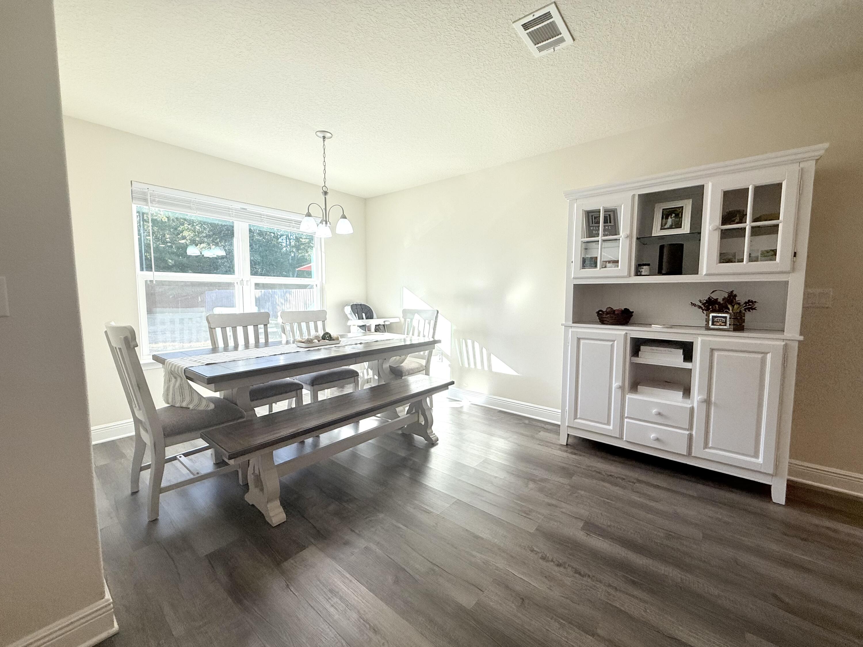 3315 Doyle Hawkins Road Navarre, FL 32566 - Photo 13 of 36 a view of a workspace with furniture window and wooden floor