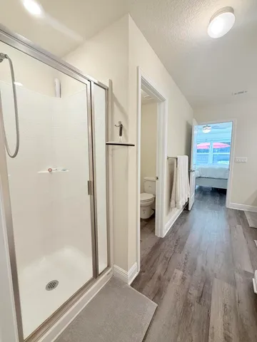 a bathroom with a sink and a glass door shower
