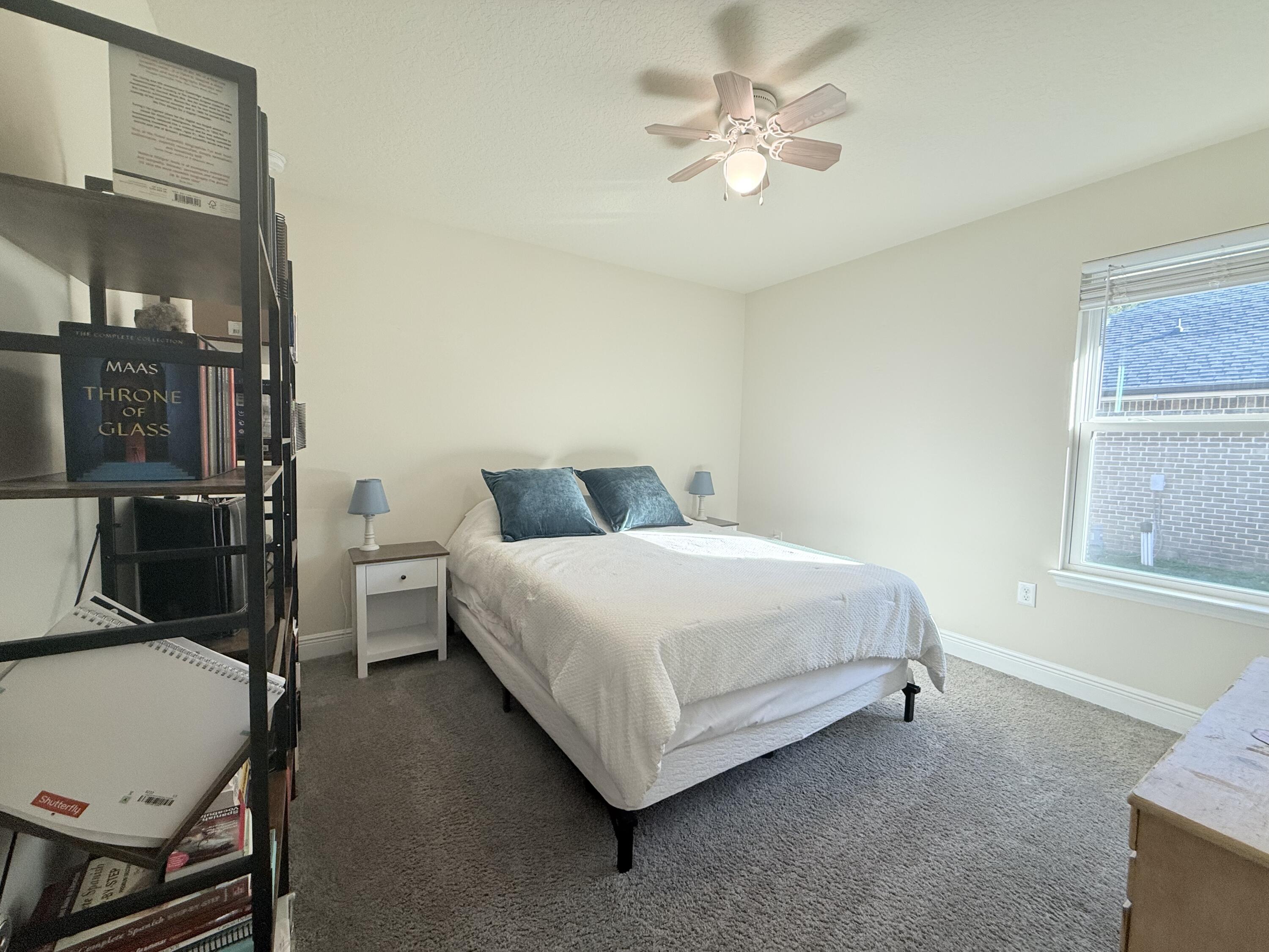 3315 Doyle Hawkins Road Navarre, FL 32566 - Photo 22 of 36 a bedroom with a bed a table and chair