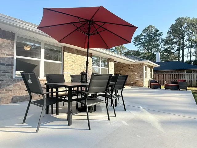 a building outdoor space with patio furniture and potted plants