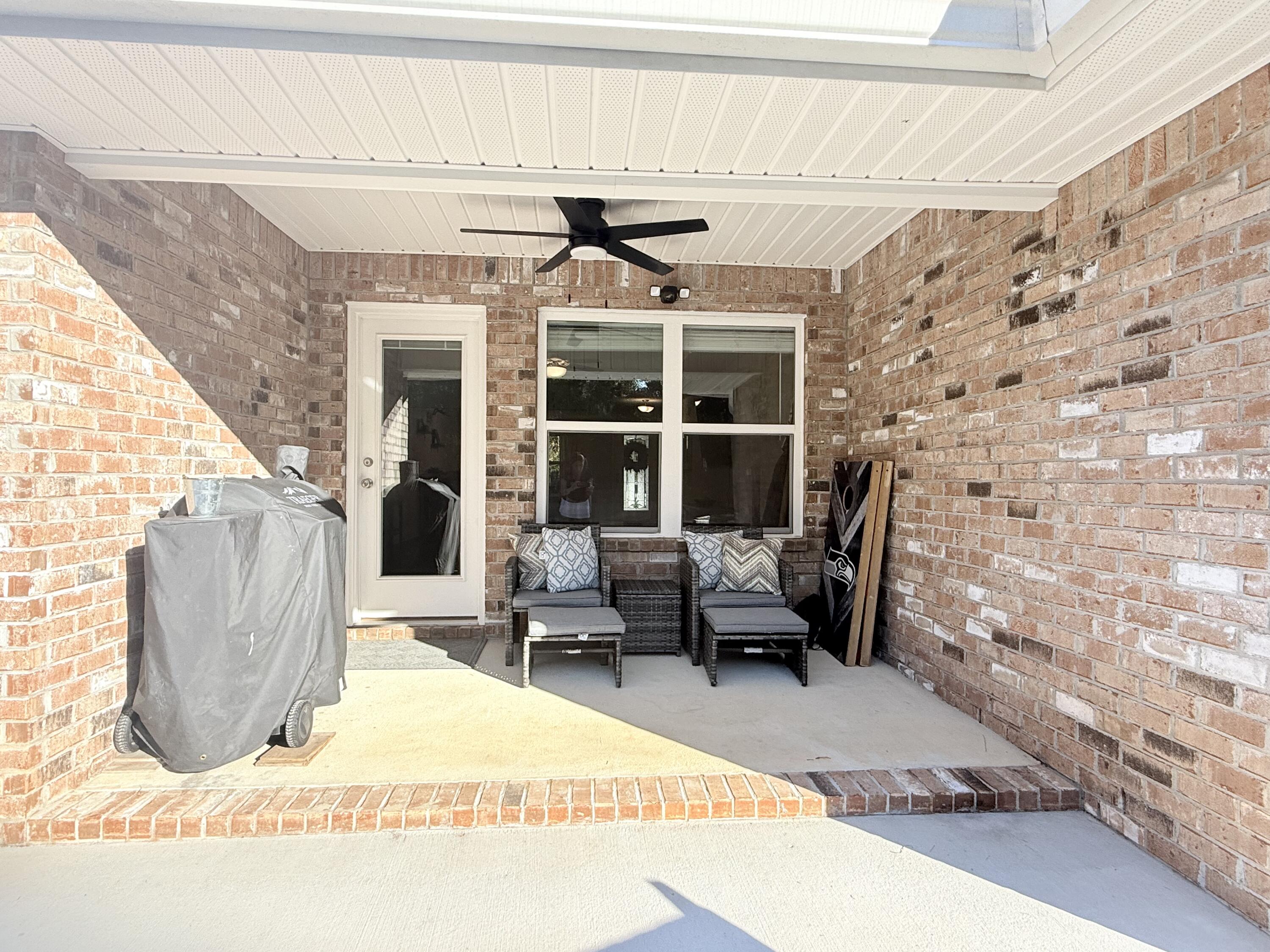3315 Doyle Hawkins Road Navarre, FL 32566 - Photo 33 of 36 a building outdoor space with patio furniture and potted plants
