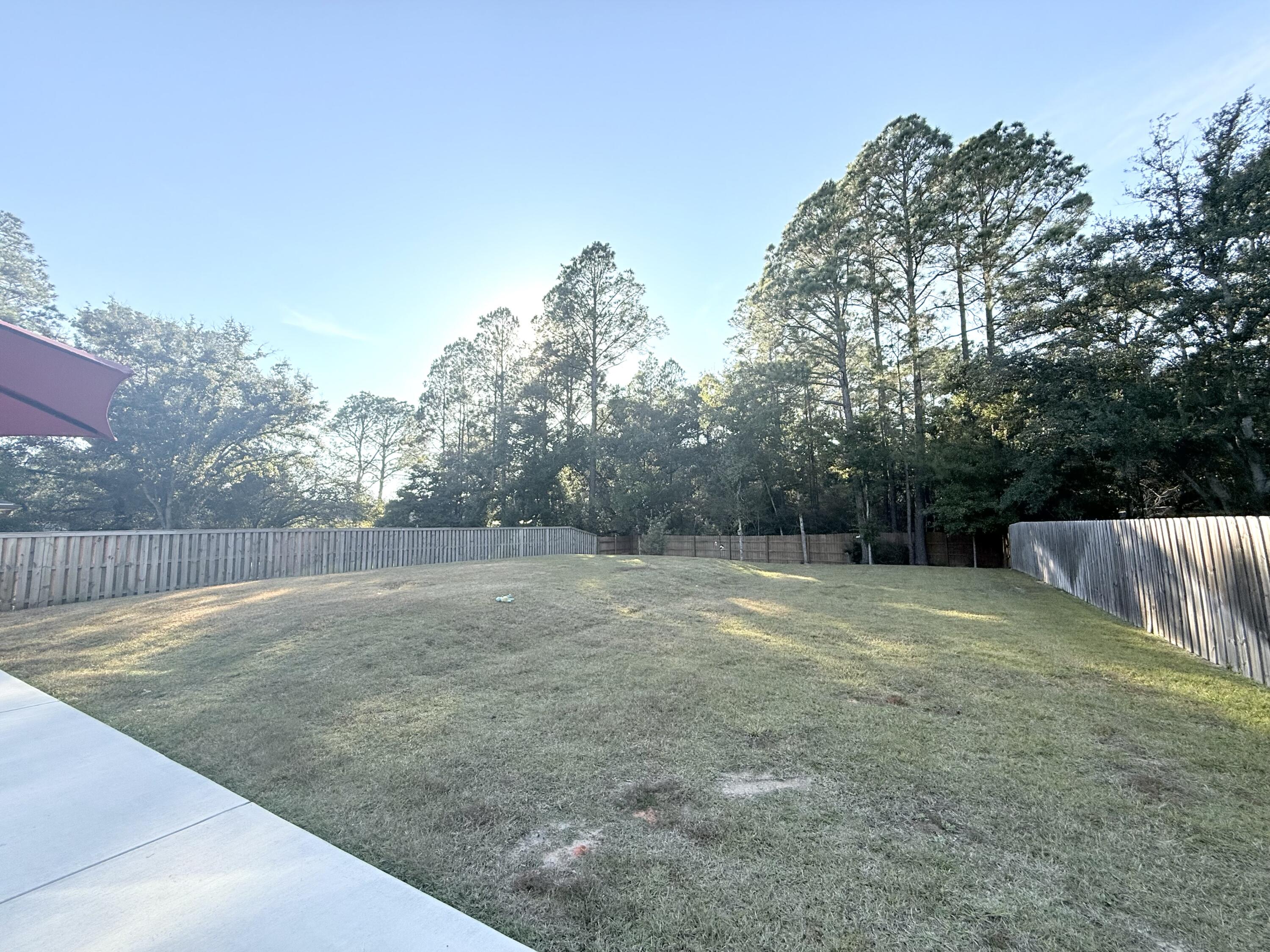3315 Doyle Hawkins Road Navarre, FL 32566 - Photo 35 of 36 a view of a backyard with a trees