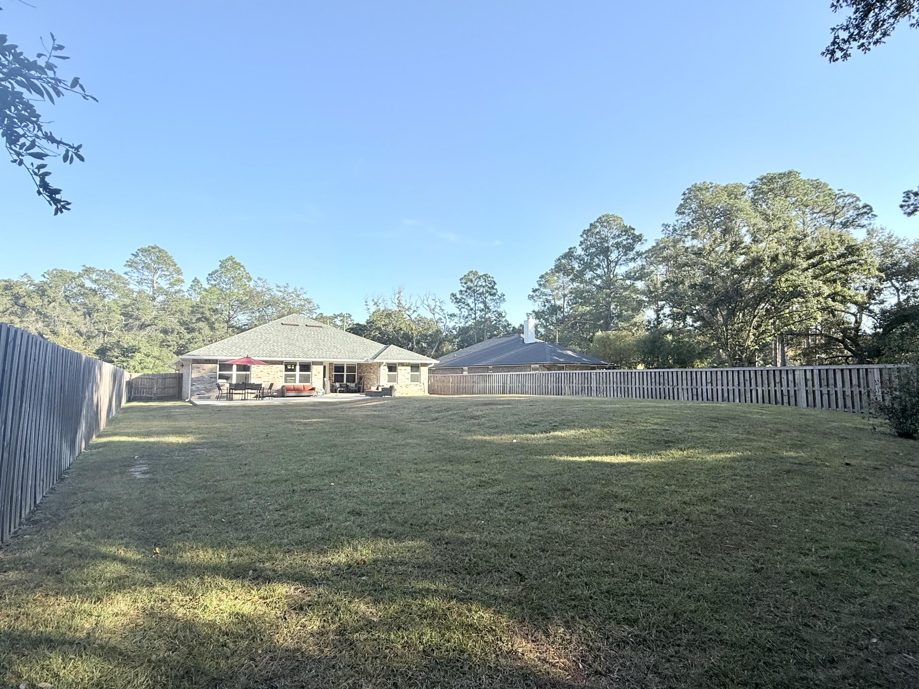 3315 Doyle Hawkins Road Navarre, FL 32566 - Photo 36 of 36 a backyard of a house with lots of green space