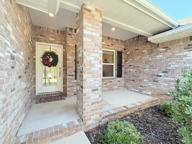 a bathroom with a granite countertop sink a mirror and shower