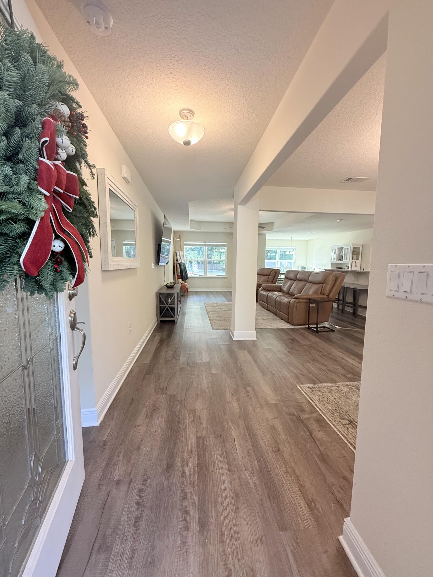 3315 Doyle Hawkins Road Navarre, FL 32566 - Photo 5 of 36 a living room with furniture and wooden floor