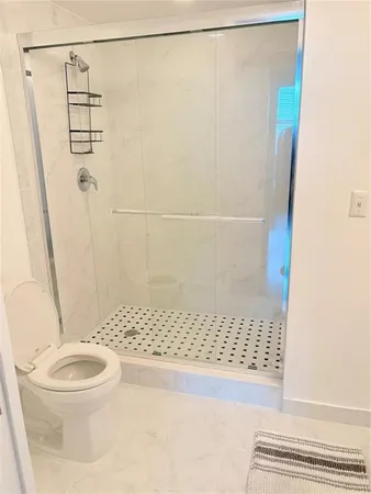 a bathroom with a shower and a sink