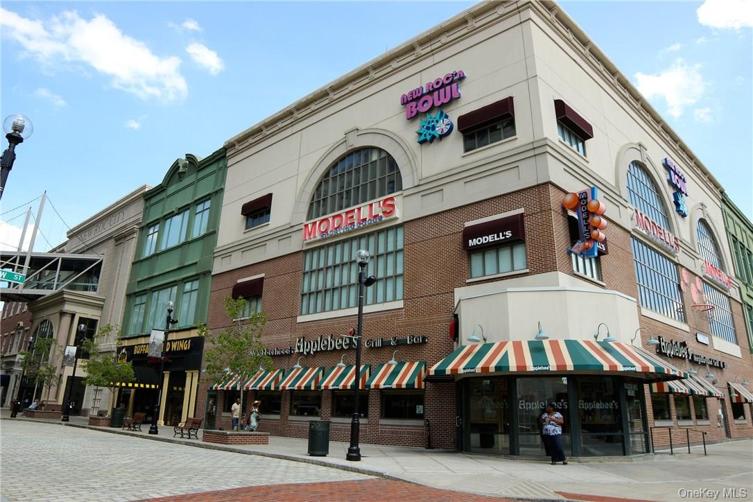 175 Huguenot Street, Unit 1405 New Rochelle, NY 10801 - Photo 18 of 20 a front view of a building with retail shop