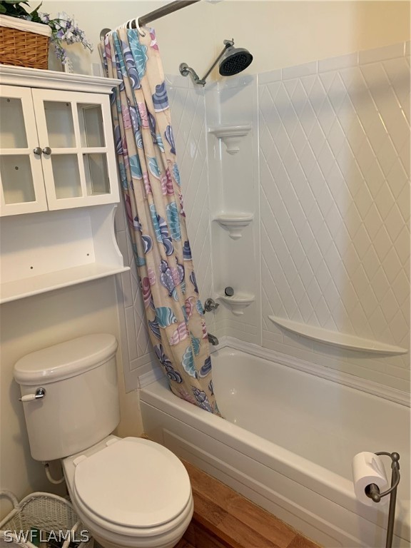 7775 Farrell Road Bokeelia, FL 33922 - Photo 17 of 33 a white toilet sitting next to a bath tub and a shower