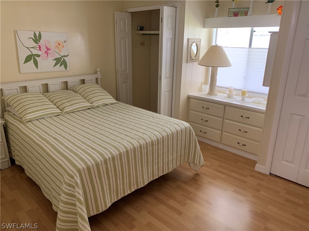 7775 Farrell Road Bokeelia, FL 33922 - Photo 21 of 33 a bedroom with a bed and a painting on the wall