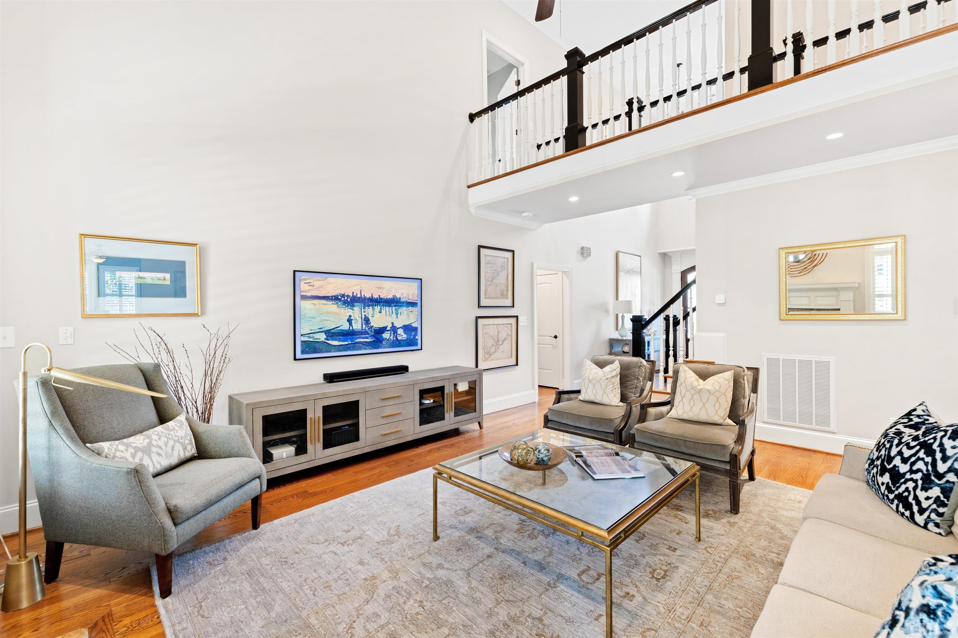 761 Wimbleton Drive Raleigh, NC 27609 - Photo 2 of 70 a living room with furniture a rug and a painting