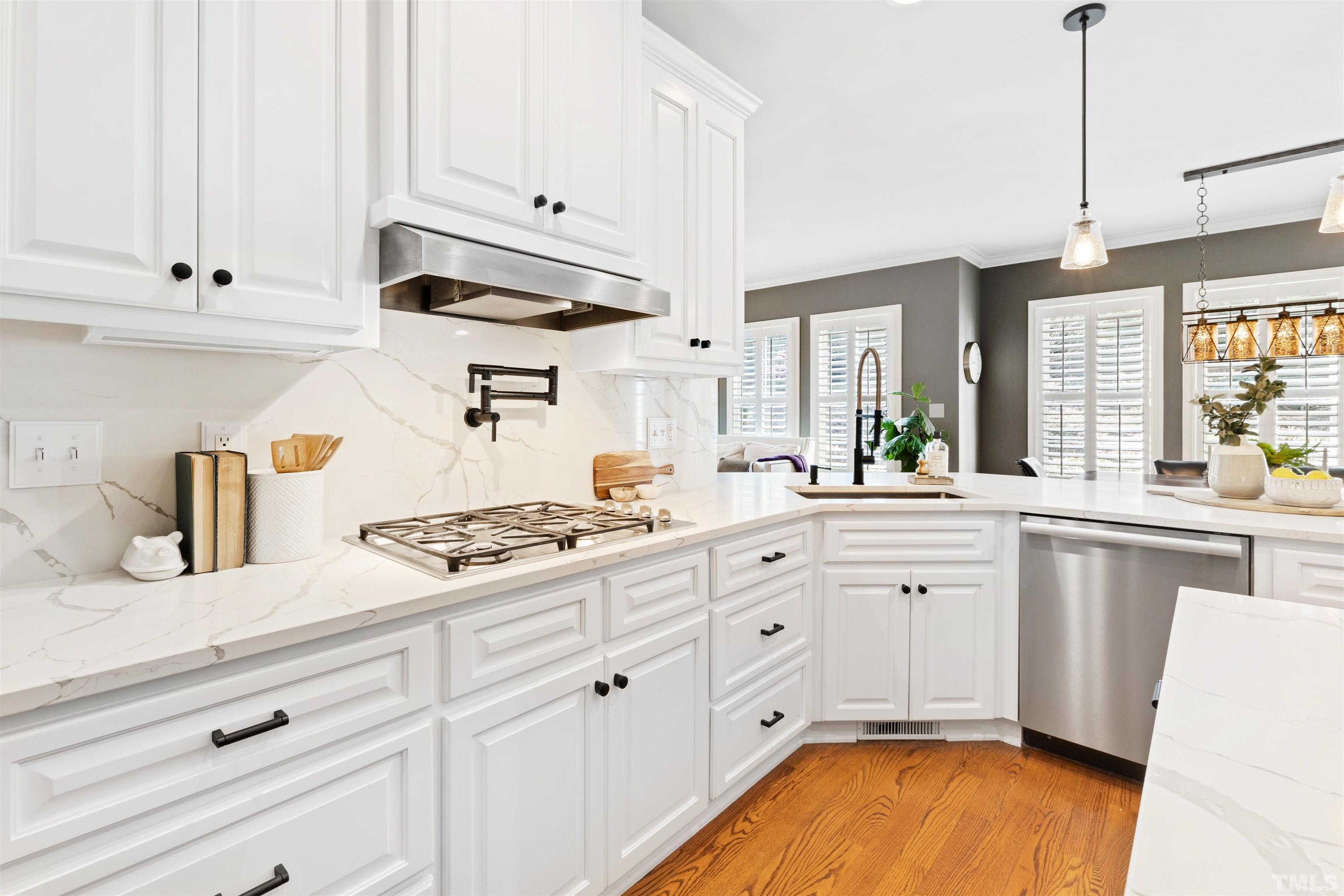 761 Wimbleton Drive Raleigh, NC 27609 - Photo 24 of 70 a kitchen with granite countertop white cabinets and white appliances