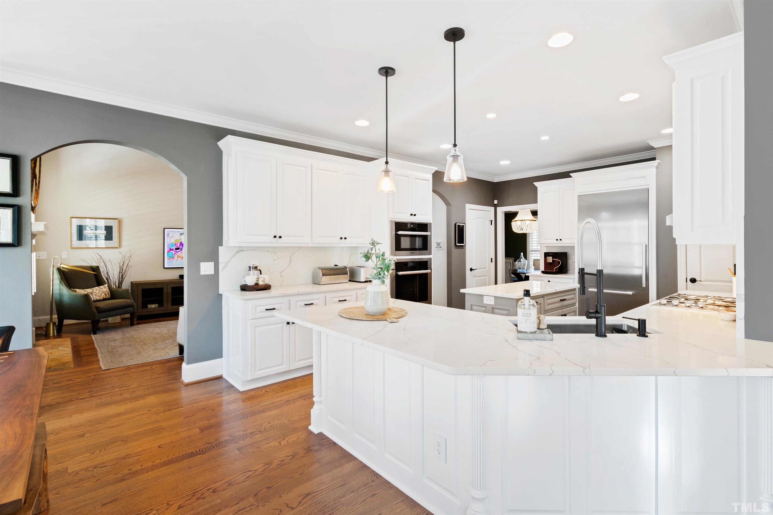 761 Wimbleton Drive Raleigh, NC 27609 - Photo 3 of 70 a room with stainless steel appliances kitchen island granite countertop a stove a sink a refrigerator and white cabinets with wooden floor
