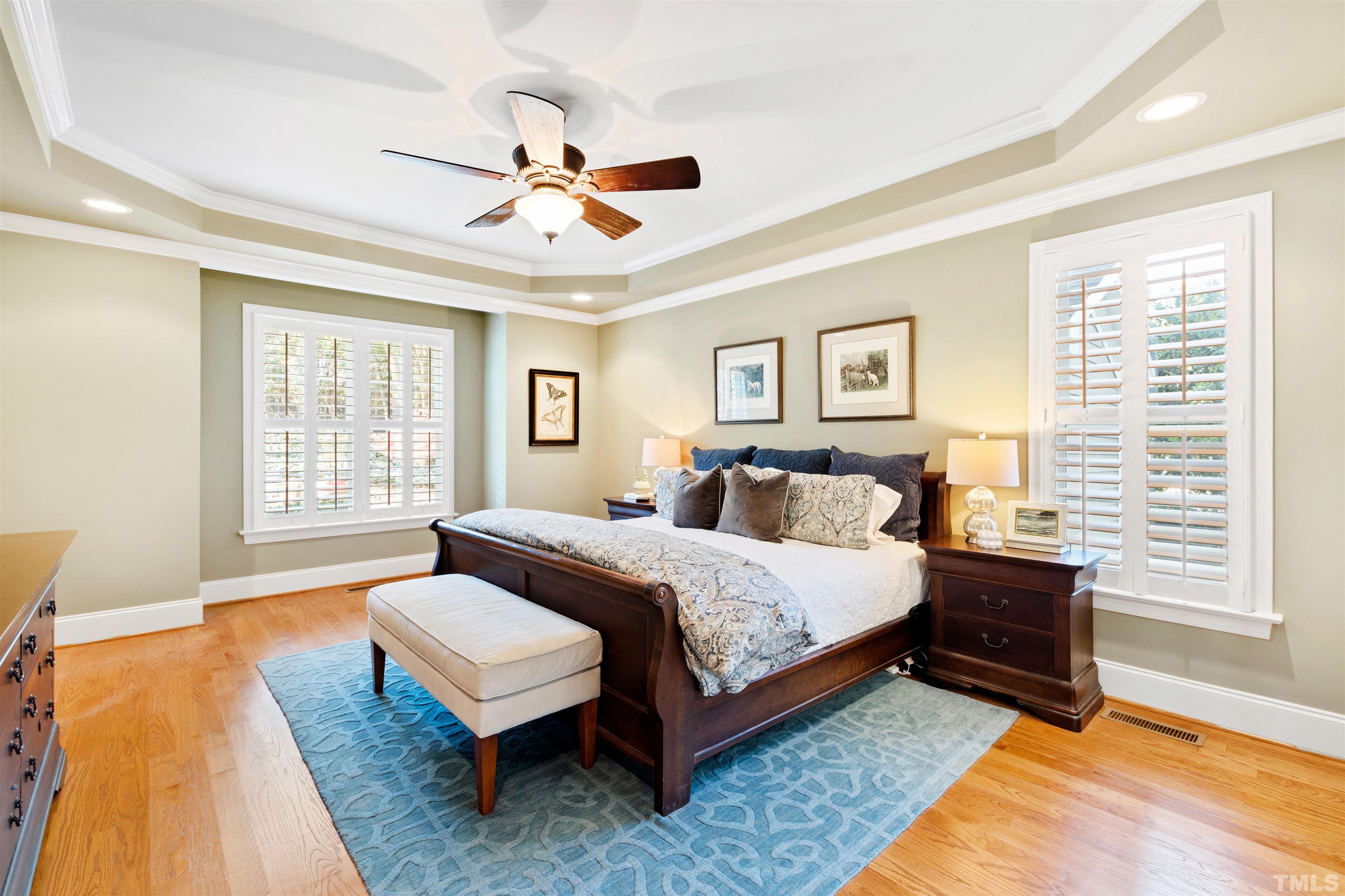761 Wimbleton Drive Raleigh, NC 27609 - Photo 33 of 70 a spacious bedroom with a bed and wooden floor