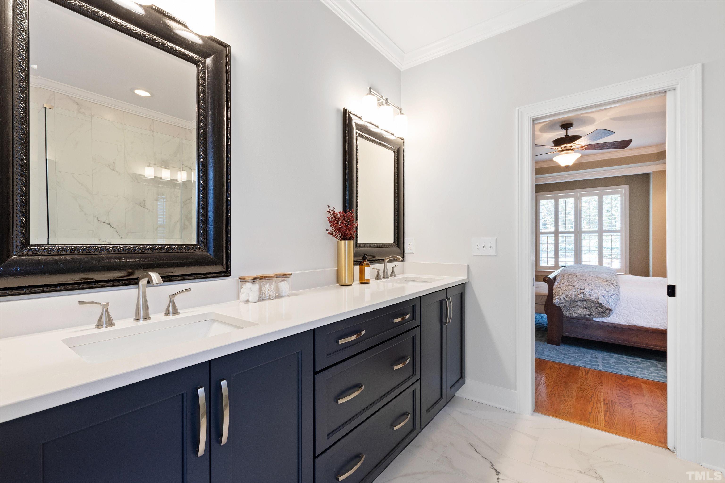 761 Wimbleton Drive Raleigh, NC 27609 - Photo 36 of 70 a en suite bathroom with a double vanity sink and a mirror