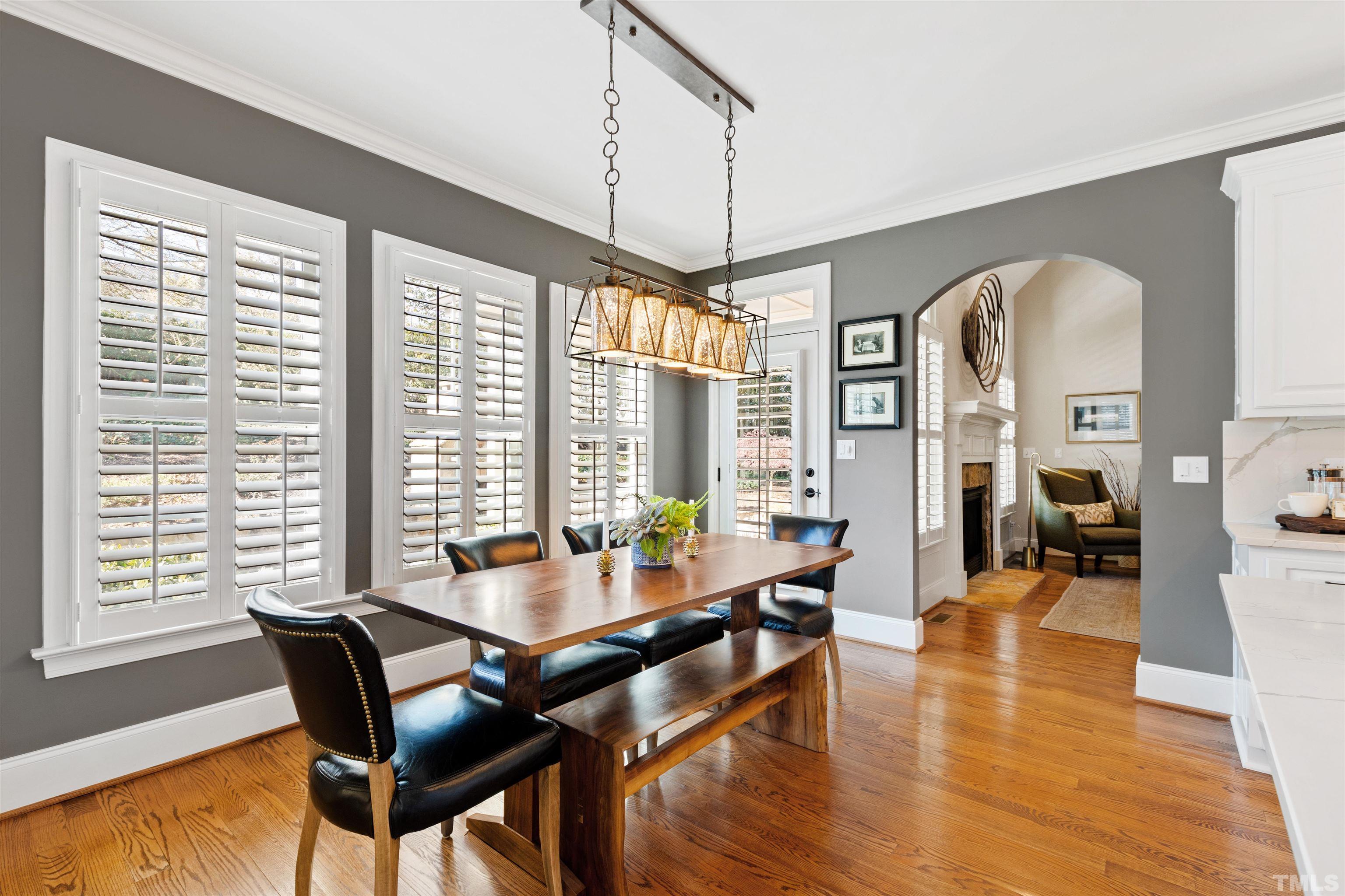 761 Wimbleton Drive Raleigh, NC 27609 - Photo 4 of 70 a dining room with wooden floor a chandelier a wooden table and chairs