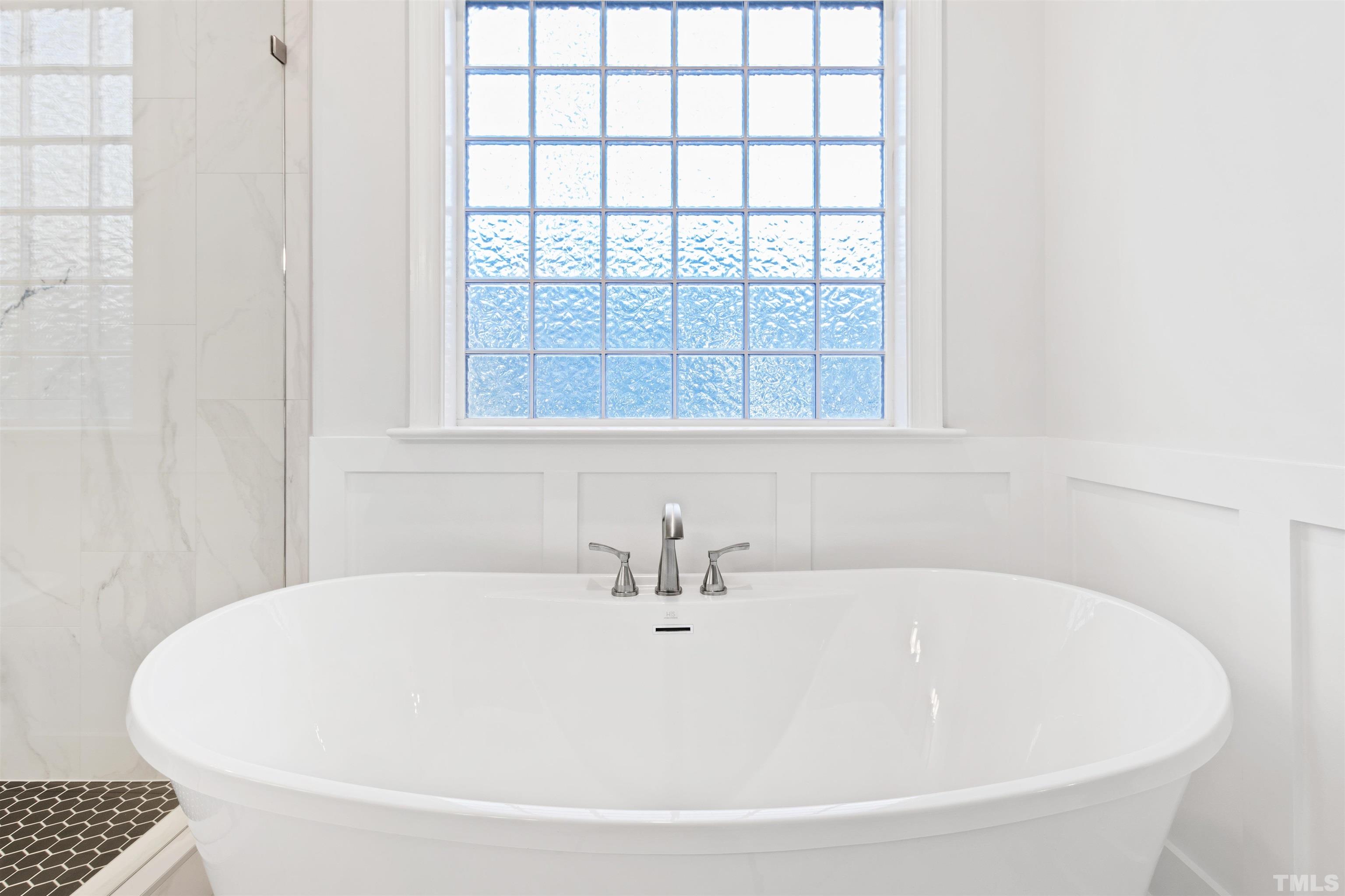 761 Wimbleton Drive Raleigh, NC 27609 - Photo 41 of 70 a white bath tub sitting next to a window