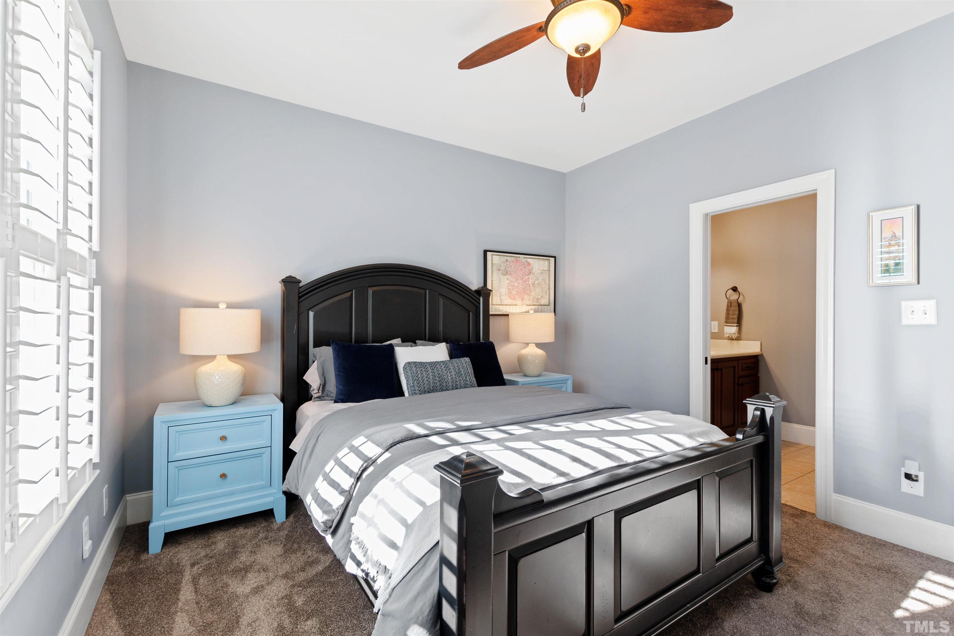 761 Wimbleton Drive Raleigh, NC 27609 - Photo 47 of 70 a bedroom with a bed and a chandelier