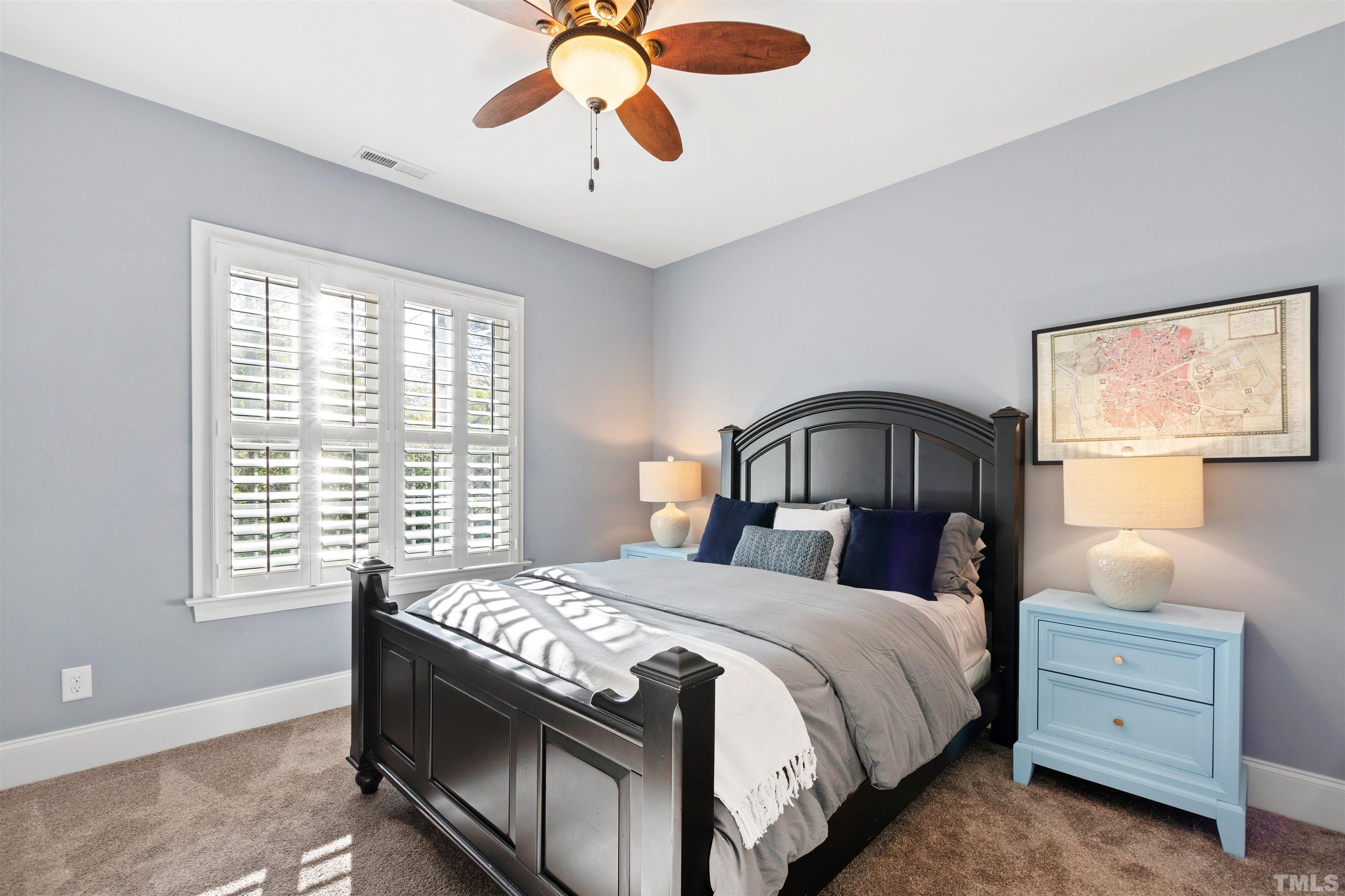 761 Wimbleton Drive Raleigh, NC 27609 - Photo 49 of 70 a bedroom with a bed and a chandelier