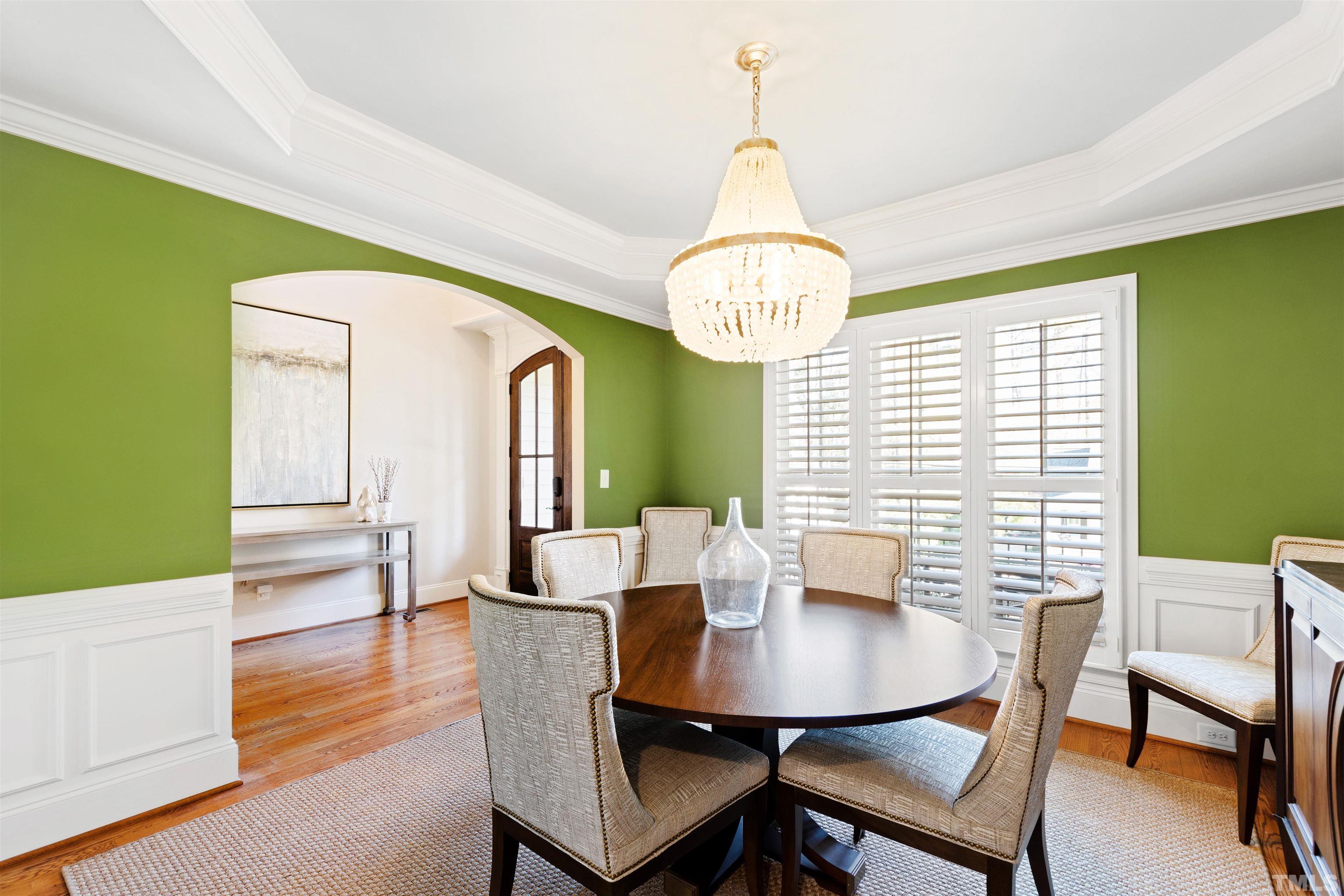 761 Wimbleton Drive Raleigh, NC 27609 - Photo 5 of 70 a view of a dining room with furniture a chandelier and wooden floor