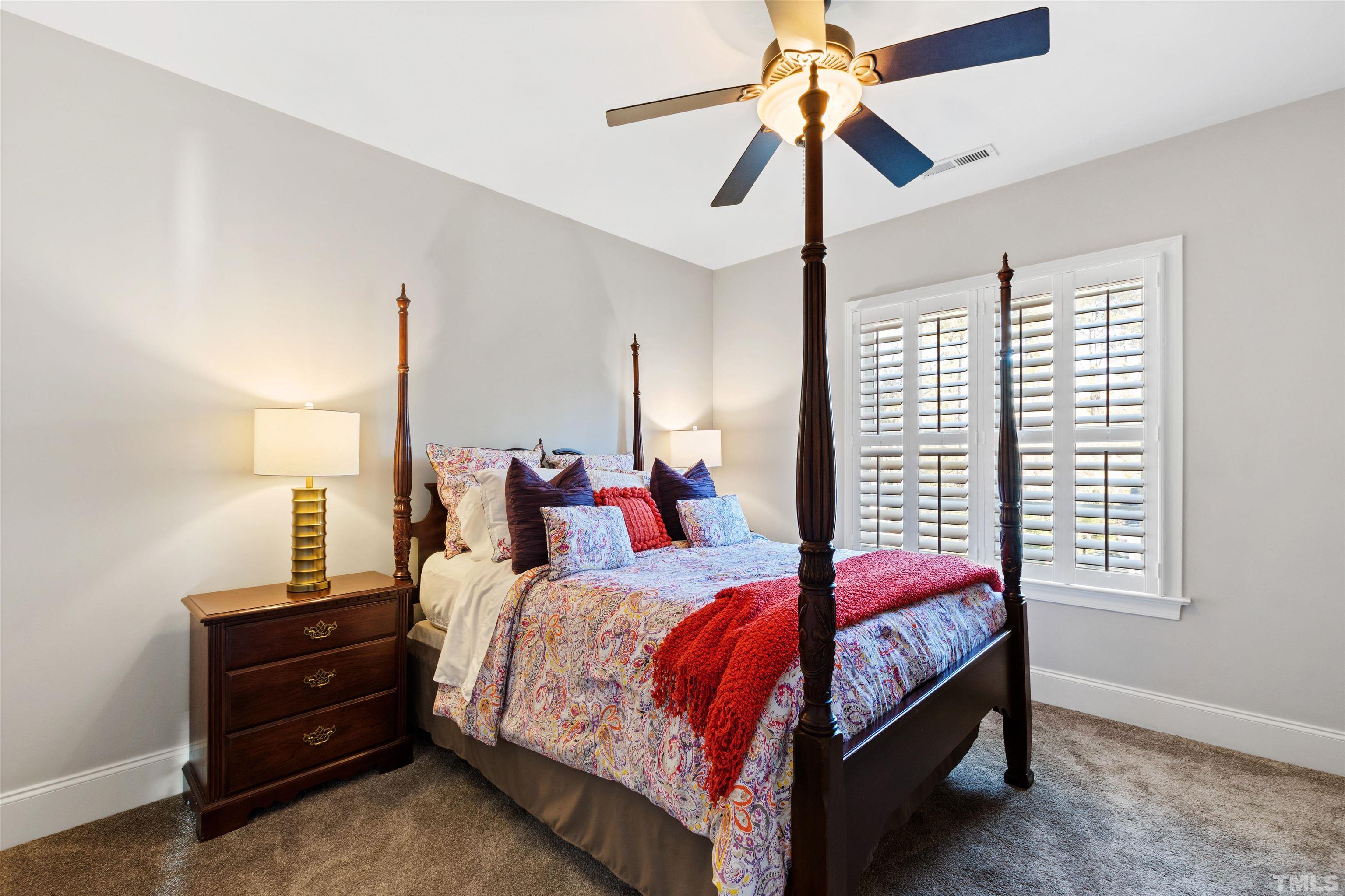 761 Wimbleton Drive Raleigh, NC 27609 - Photo 52 of 70 a bedroom with a bed and a chandelier