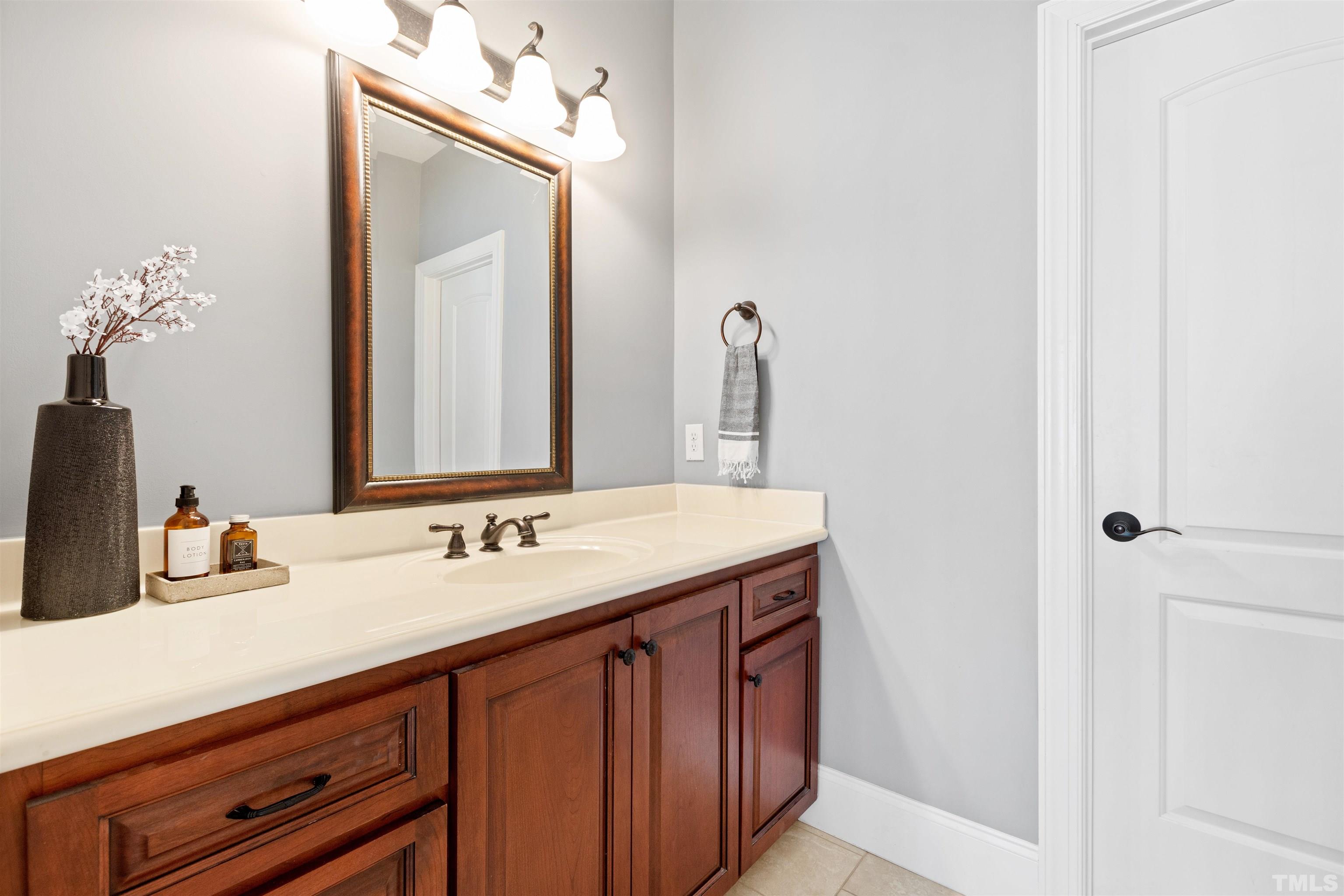 761 Wimbleton Drive Raleigh, NC 27609 - Photo 56 of 70 a bathroom with a sink vanity and a mirror
