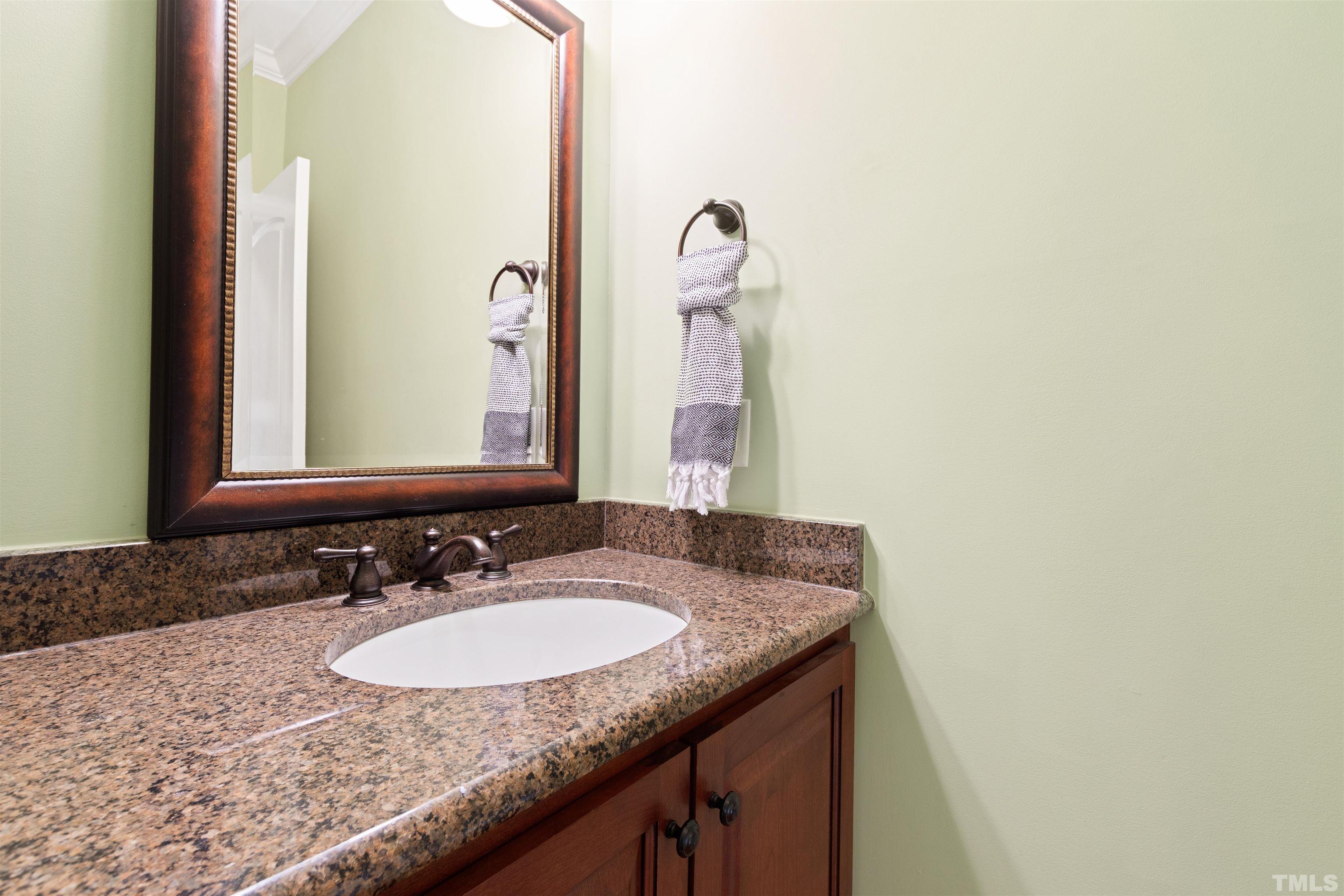761 Wimbleton Drive Raleigh, NC 27609 - Photo 58 of 70 a bathroom with a granite countertop sink and a mirror