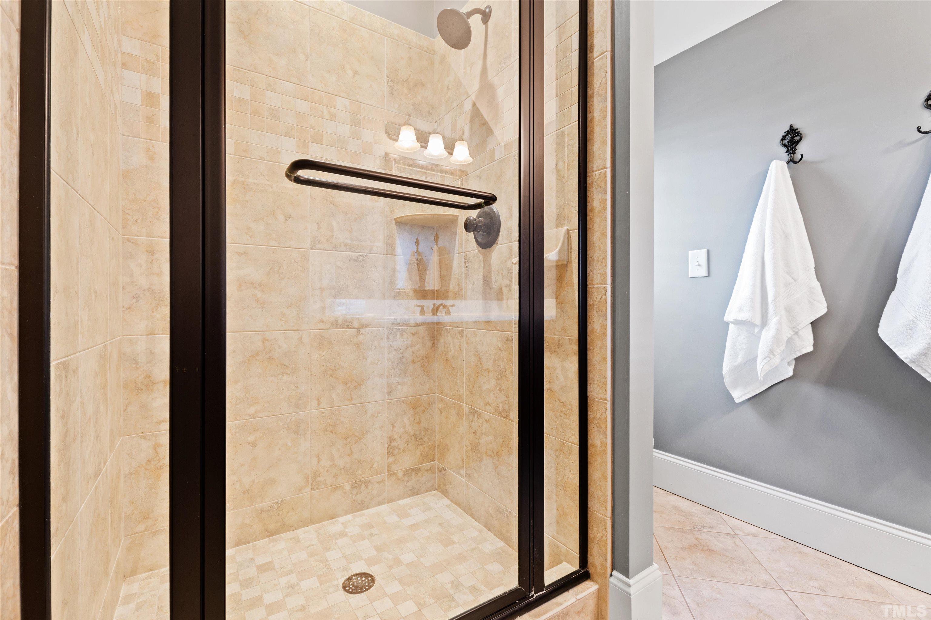 761 Wimbleton Drive Raleigh, NC 27609 - Photo 59 of 70 a bathroom with a glass shower door