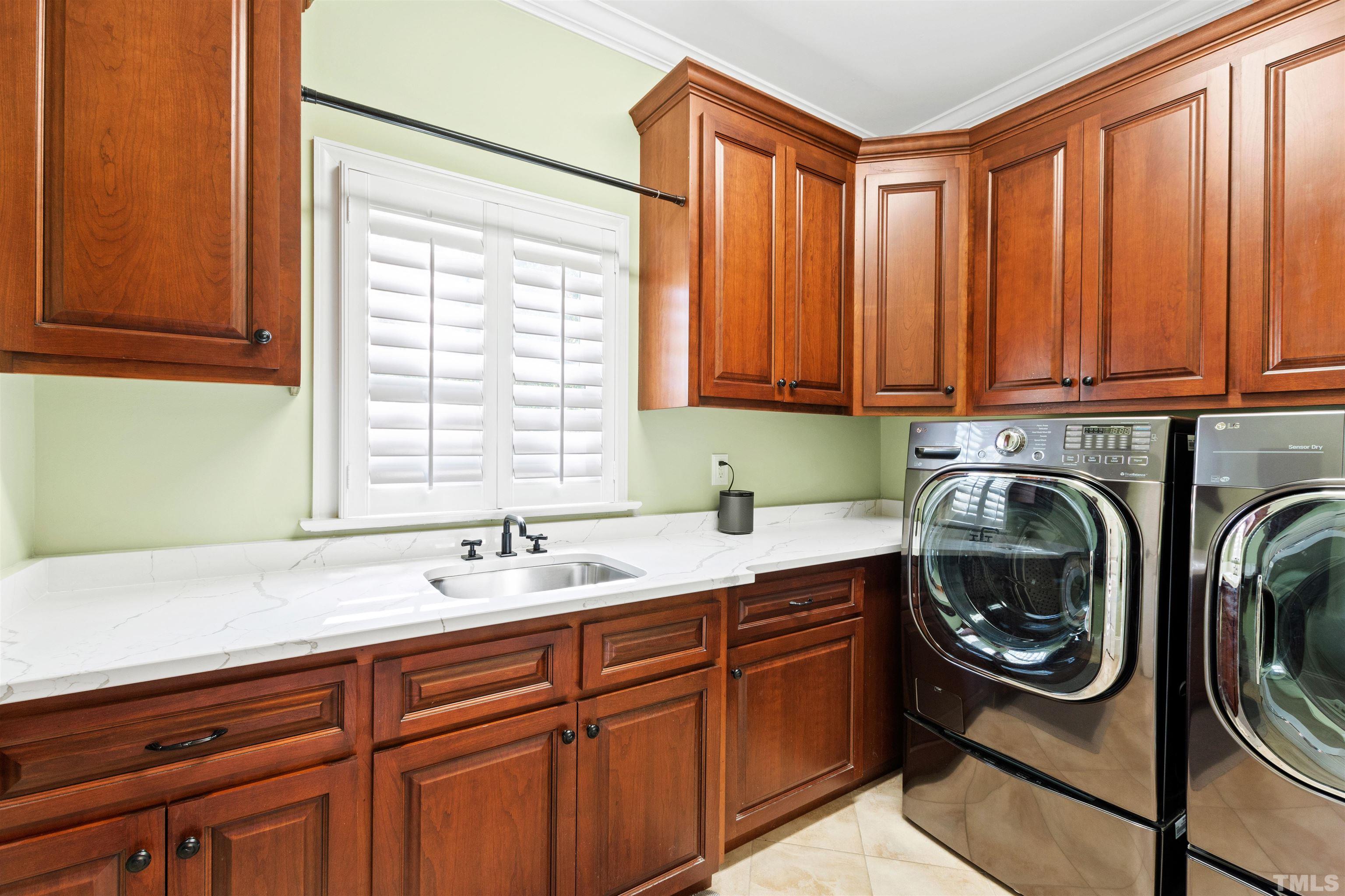 761 Wimbleton Drive Raleigh, NC 27609 - Photo 63 of 70 a utility room with stainless steel appliances white cabinets and a window