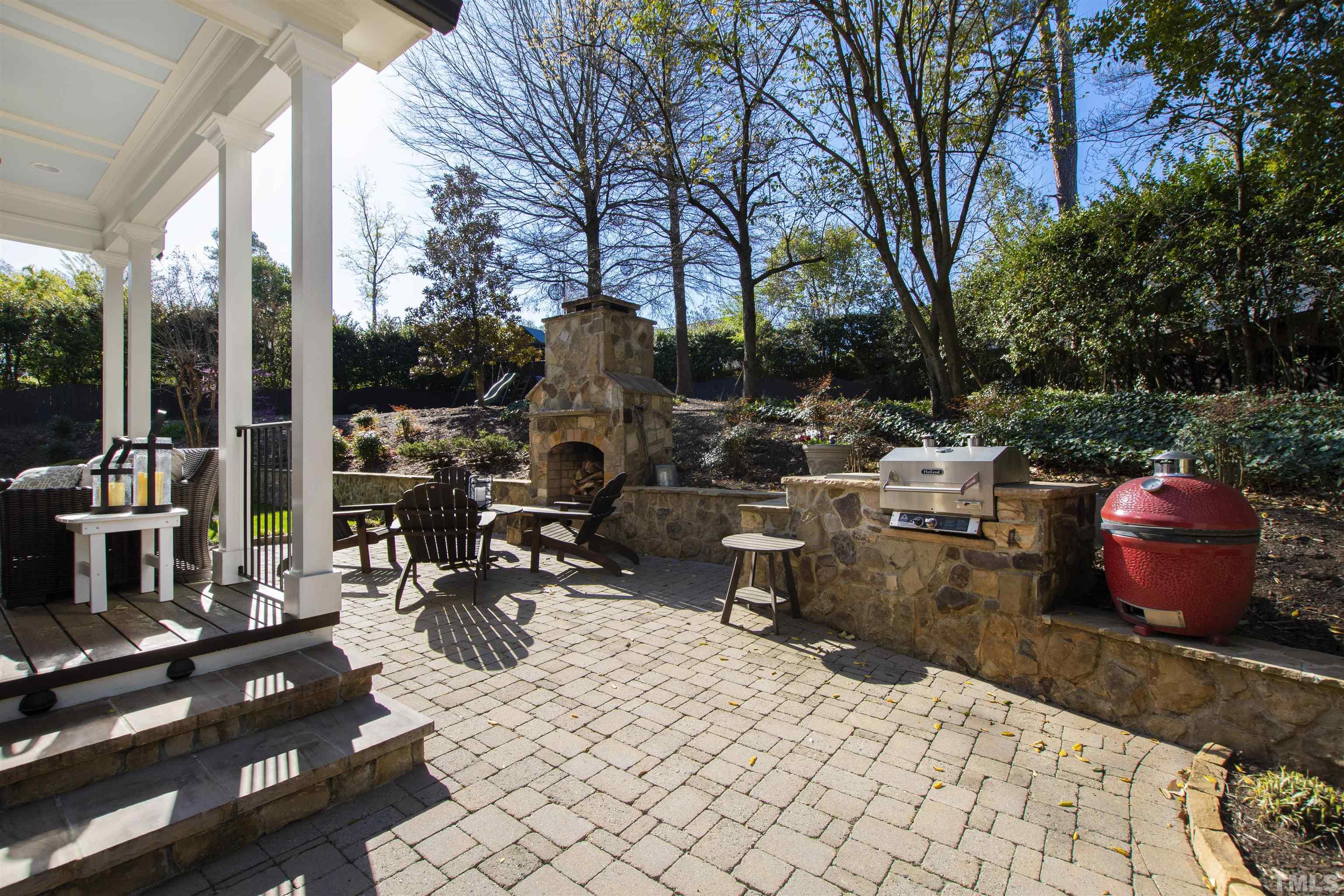 761 Wimbleton Drive Raleigh, NC 27609 - Photo 8 of 70 a view of a patio with table and chairs potted plants and a large tree